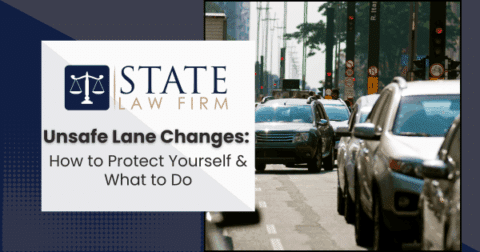 Street with heavy traffic next to law firm sign