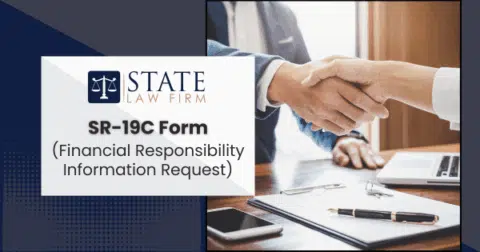 Two individuals shaking hands over an office desk