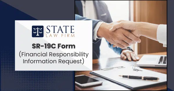 Two individuals shaking hands over an office desk